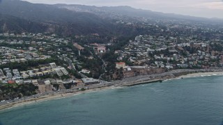 AX0156_165 - 7.6K aerial stock footage of light morning traffic on Pacific Coast Highway in Pacific Palisades, California