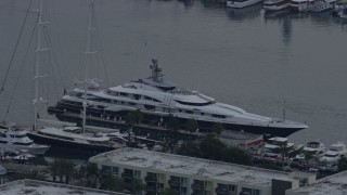 AX0156_175 - 7.6K aerial stock footage of a mega yacht with a helicopter docked in Marina Del Rey, California