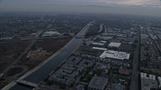 AX0156_178 - 7.6K aerial stock footage flying alongside the Los Angeles river canal, sunrise, Marina Del Rey, California