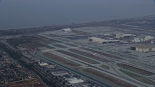 AX0156_184 - 7.6K aerial stock footage tracking an airplane taking off from LAX, sunrise, Los Angeles, California