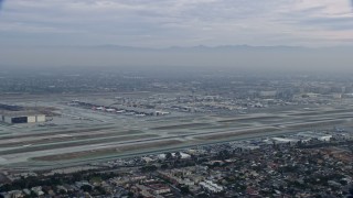 AX0156_188 - 7.6K aerial stock footage of LAX at sunrise on a cloudy day, Los Angeles, California