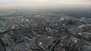 AX0156_195E - 7.6K aerial stock footage of an oil refinery in El Segundo, California, sunrise