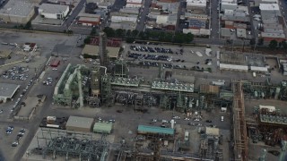 AX0156_197 - 7.6K aerial stock footage flying by an oil refinery structures in the morning in El Segundo, California
