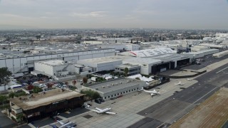 AX0156_203E - 7.6K aerial stock footage flying by SpaceX HQ and the Tesla Design Center in the morning, Hawthorne, California