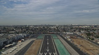 AX0157_001 - 7.6K aerial stock footage taking off from Hawthorne Airport and fly over residential area, Hawthorne, California