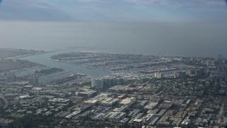 AX0157_010 - 7.6K aerial stock footage of harbors and industrial area on cloudy day, Marina Del Rey, California