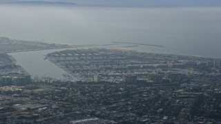 AX0157_011 - 7.6K aerial stock footage of coastal community and harbors, hazy, Marina Del Rey, California