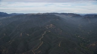 AX0157_014 - 7.6K aerial stock footage approach the Santa Monica Mountains with marine layer in California