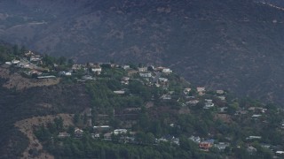 AX0157_015 - 7.6K aerial stock footage of hillside homes in the Santa Monica Mountains, Pacific Palisades, California