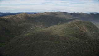 AX0157_016E - 7.6K aerial stock footage of rolling green Santa Monica Mountains, California