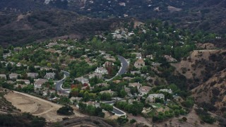 AX0157_022 - 7.6K aerial stock footage flying by homes on a hill in Topanga, California