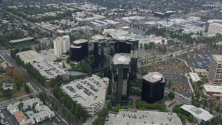 AX0157_023E - 7.6K aerial stock footage of Warner Center office buildings in Woodland Hills, California