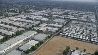 AX0157_056E - 7.6K aerial stock footage of mobile homes and warehouse buildings in Chatsworth, California