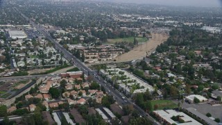 AX0157_070 - 7.6K aerial stock footage flying over suburban homes and apartment buildings in Northridge, California