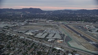 AX0158_001 - 7.6K aerial stock footage dying by Burbank airport at twilight, Burbank, California