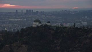 AX0158_006 - 7.6K aerial stock footage of Griffith Observatory at twilight against the hills, California
