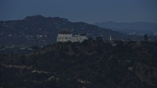 AX0158_007E - 7.6K aerial stock footage tracking Griffith Observatory and reveal Hollywood Sign, twilight, Los Angeles, California
