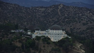 AX0158_010 - 7.6K aerial stock footage of the front of Griffith Observatory at twilight, Los Angeles, California