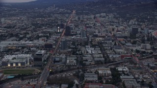 AX0158_015 - 7.6K aerial stock footage approaching Sunset Boulevard and neighboring businesses, twilight, Hollywood, California