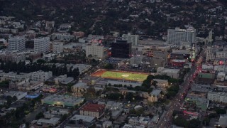 AX0158_018 - 7.6K aerial stock footage of Hollywood High School football field, twilight, Hollywood, California