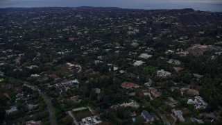 AX0158_022 - 7.6K aerial stock footage of upscale homes and mansions, twilight, Beverly Hills, California