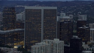 AX0158_028 - 7.6K aerial stock footage passing by Century Plaza Towers, twilight, Century City, California