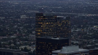 AX0158_031E - 7.6K aerial stock footage orbiting office and apartment buildings, twilight, Century City, California