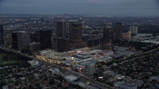 AX0158_033 - 7.6K aerial stock footage orbiting Westfield shopping mall and bordering office buildings, twilight, Century City, California