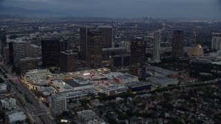 AX0158_034E - 7.6K aerial stock footage orbiting office buildings and skyscrapers at twilight, Century City, California