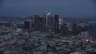 AX0158_044 - 7.6K aerial stock footage of Downtown Los Angeles skyline with new skyscraper, Wilshire Grand Center, twilight, California