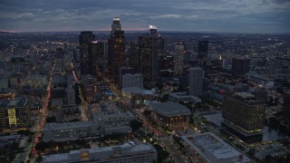 AX0158_050E - 7.6K aerial stock footage of tall skyscrapers at twilight in Downtown Los Angeles, California