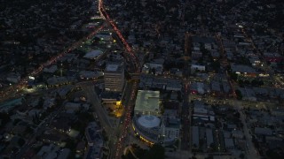 AX0158_054 - 7.6K aerial stock footage approaching and tilt to the Angelus Temple and parking garage at twilight in Echo Park, Los Angeles, California