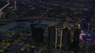 AX0158_060 - 7.6K stock footage aerial video orbiting Oceanwide Plaza to reveal Staples Center at twilight in Downtown Los Angeles, California