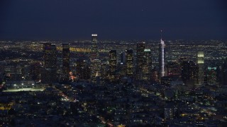 AX0158_073 - 7.6K stock footage aerial video approaching the Downtown Los Angeles skyline at night, California