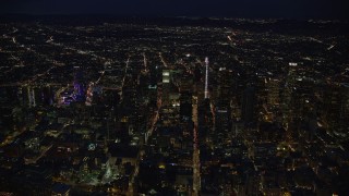 AX0158_080E - 7.6K aerial stock footage of a wide view of skyscrapers at night in Downtown Los Angeles, California