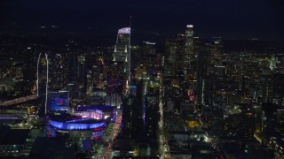 AX0158_092 - 7.6K stock footage aerial video of Staples Center and skyscrapers at night in Downtown Los Angeles, California