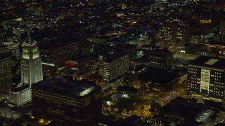 AX0158_098 - 7.6K aerial stock footage of City Hall, LAPD Headquarters, LA Times building at night, Downtown Los Angeles, California