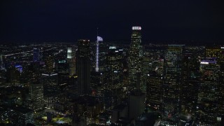 AX0158_110 - 7.6K stock footage aerial video approaching skyscrapers at night in Downtown Los Angeles, California