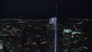 AX0158_112 - 7.6K aerial stock footage orbiting Wilshire Grand Center at night in Downtown Los Angeles, California