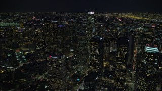 AX0158_120 - 7.6K aerial stock footage flying by skyscrapers at night, and approach US Bank Tower, Downtown Los Angeles, California