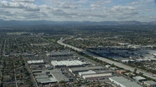 AX0159_002 - 7.6K aerial stock footage flying over the 118 freeway and warehouses, Pacoima, San Fernando Valley, California