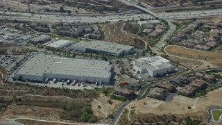 AX0159_008E - 7.6K aerial stock footage of a Warehouse and Industrial buildings near the interstate, Sylmar, San Fernando Valley, California