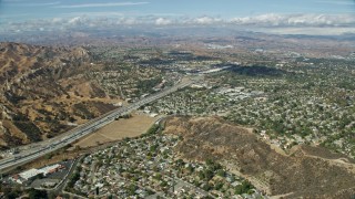 AX0159_012 - 7.6K stock footage aerial video flying over suburban neighborhoods along I-5, Santa Clarita, California