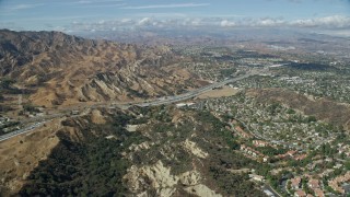 AX0159_012E - 7.6K aerial stock footage of Wiley Canyon Elementary School, storage facilities and retail spaces, Santa Clarita, California