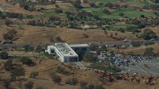 AX0159_024 - 7.6K aerial stock footage of Academy of the Canyons and Interstate 5 with light traffic, Santa Clarita, California