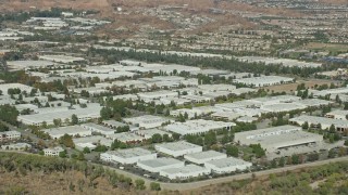 AX0159_033 - 7.6K stock footage aerial video approaching multiple office buildings and warehouses, Valencia, California
