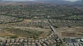 AX0159_046E - 7.6K aerial stock footage flying over tract homes, Valencia, California