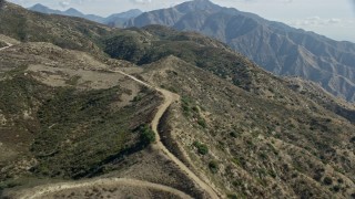 AX0159_058 - 7.6K aerial stock footage flying over canyon trails, Sunland-Tujunga, California