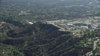 AX0159_066 - 7.6K aerial stock footage approaching JPL from behind a mountain ridge, Pasadena, California