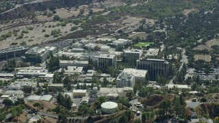 AX0159_076E - 7.6K aerial stock footage of a reverse shot of scientific facility buildings, JPL, Pasadena, Caliofrnia